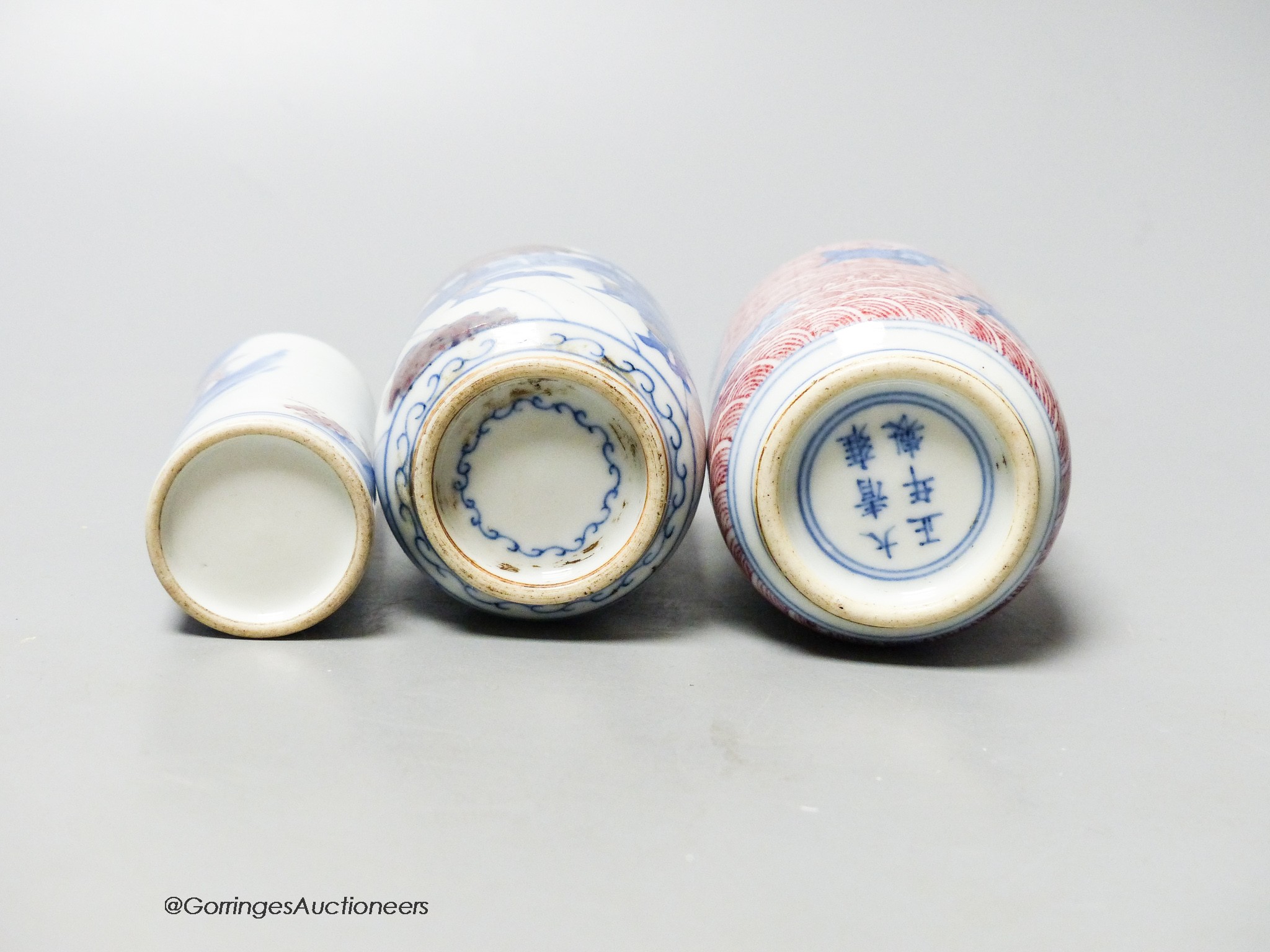Three Chinese underglaze blue and copper red snuff bottles, 9cm